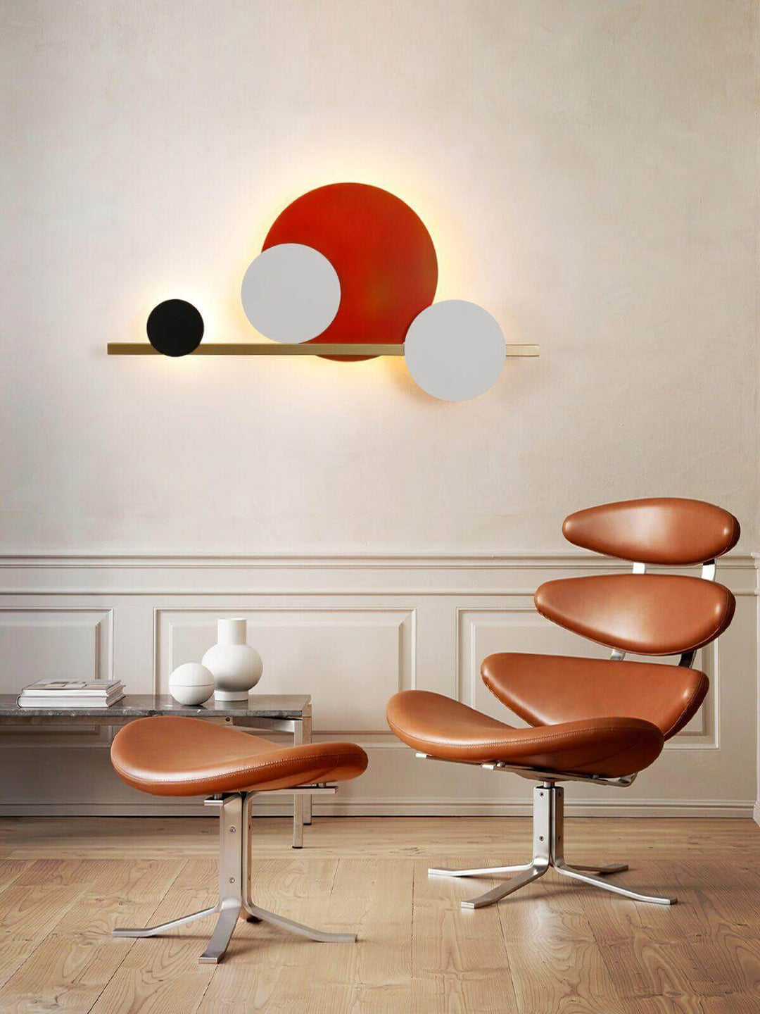 Modern circle LED wall light above a stylish brown chair, perfect as accent wall lighting for contemporary decor.