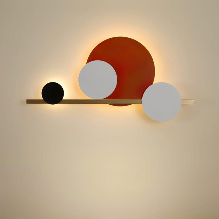 Modern circle LED wall light in red, black, and white design, perfect for bedroom accent wall lighting.