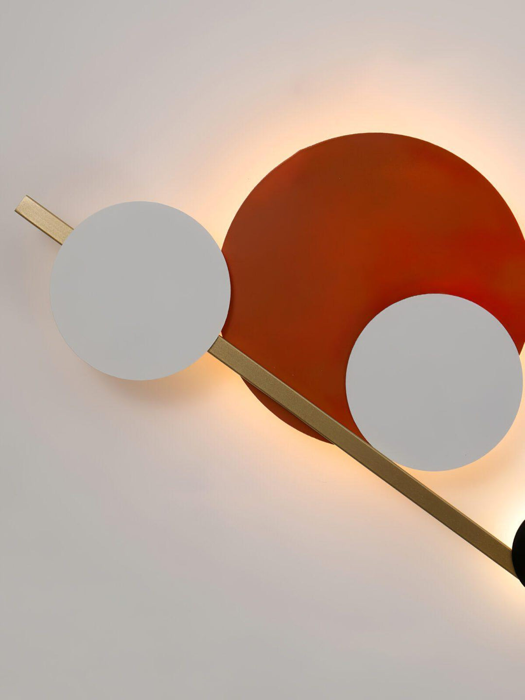 Modern wall sconce with circular shapes and gold accents, perfect accent wall lighting for bedroom decor.