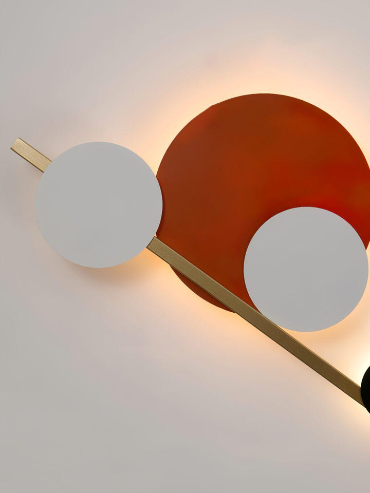 Modern wall sconce with circular shapes and gold accents, perfect accent wall lighting for bedroom decor.