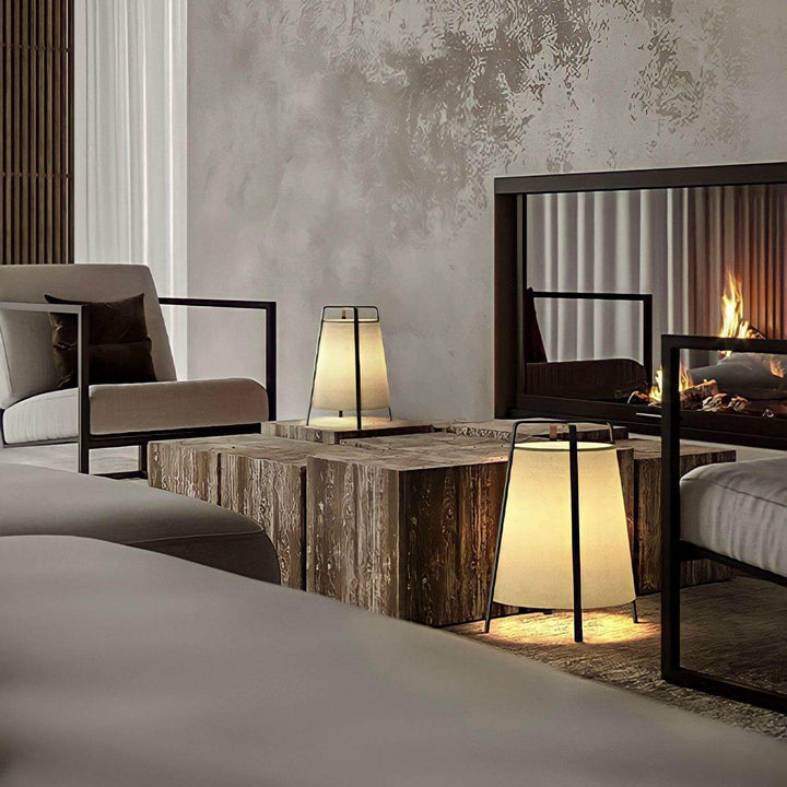 Cozy living room with vintage-style table lamps, modern seating, and a warm fireplace ambiance.