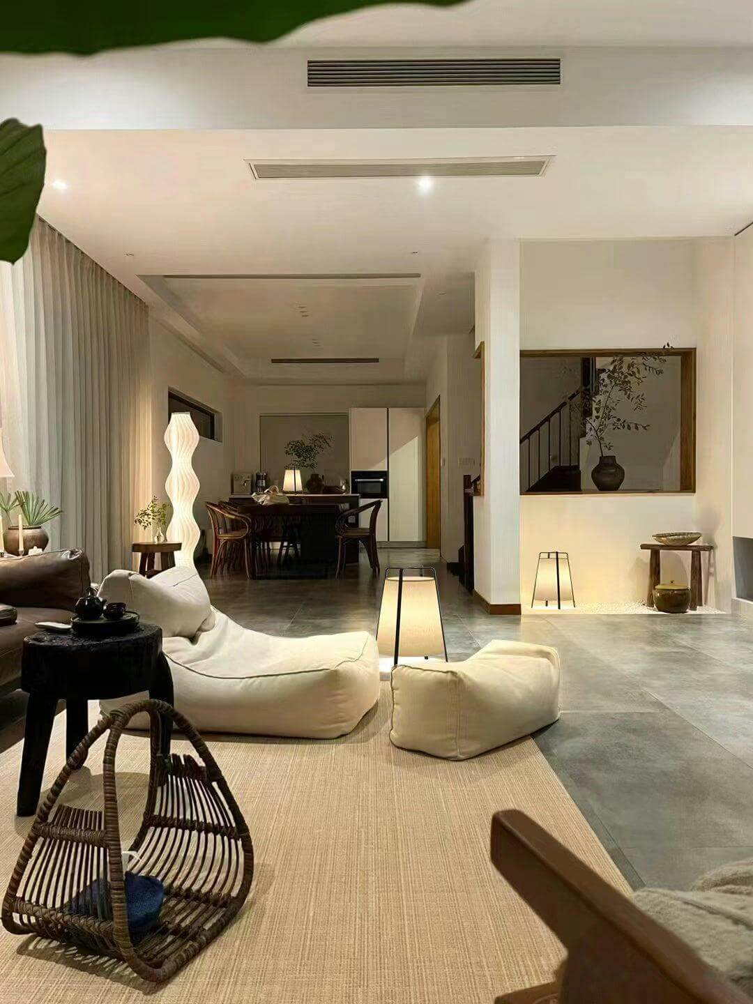 Spacious living room with modern design, featuring unique table lamps and cozy seating for relaxation.