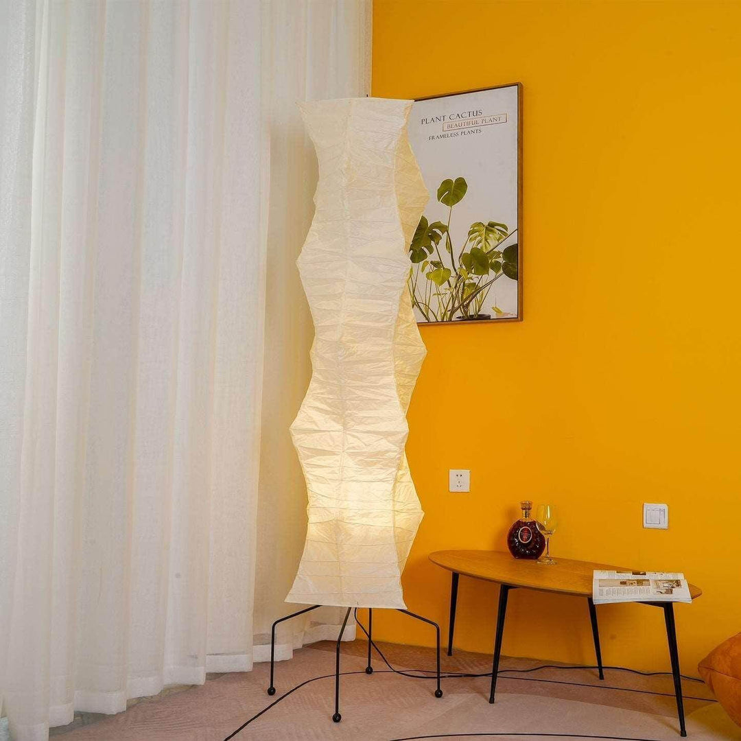 Akari UF4-33N white rice paper floor lamp in a minimalist design, illuminating a cozy corner with a warm glow.