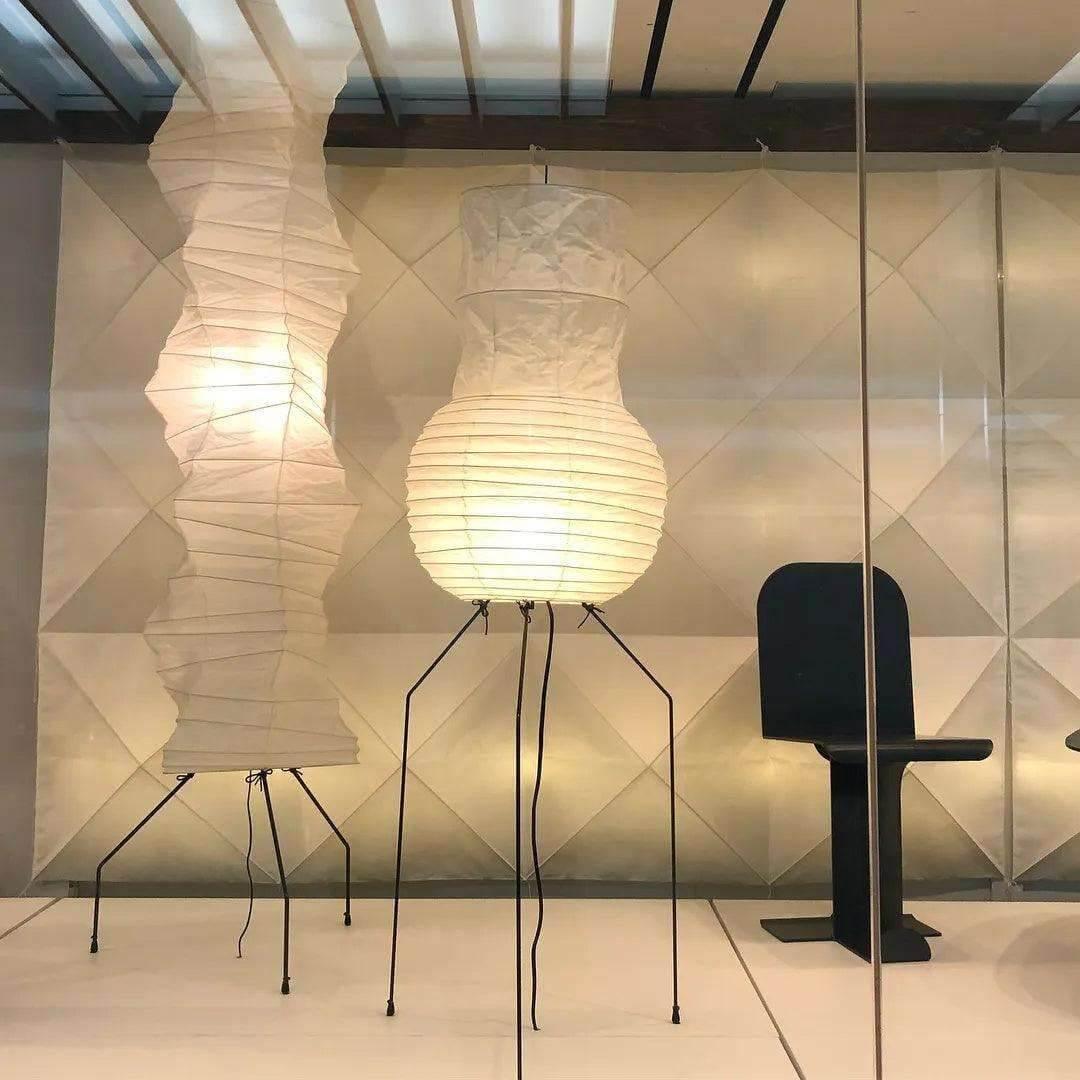 Japanese floor lamp featuring a minimalist design with white rice paper and stylish metal legs for modern interiors.