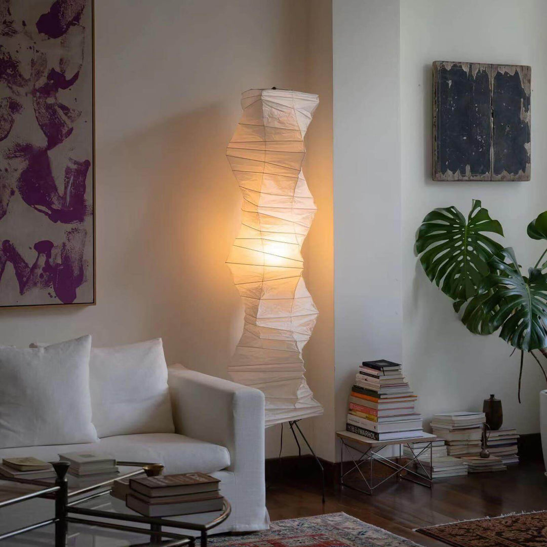 Elegant Akari UF4-33N white floor lamp in a cozy living room, showcasing a minimalist Japanese design with warm illumination.
