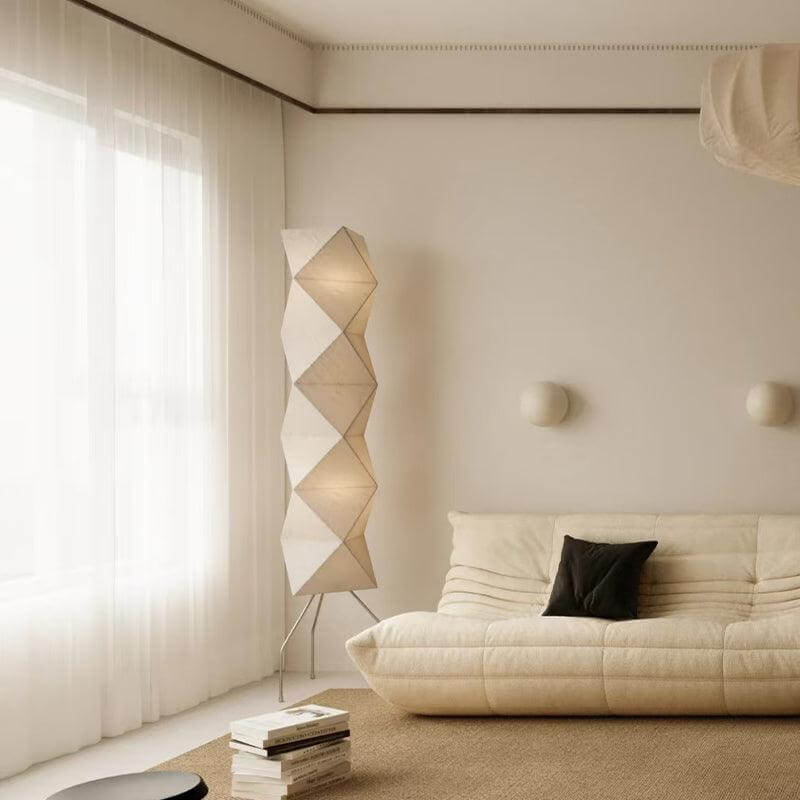 Akari UF4-L8 minimalist Japanese floor lamp in a modern living room with white rice paper design.