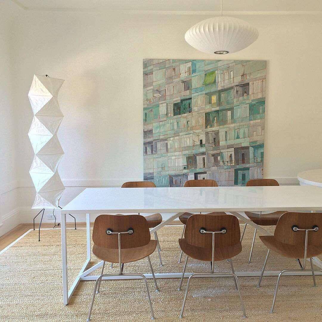 Akari UF4-L8 minimalist white rice paper floor lamp in modern dining room with a large canvas artwork.