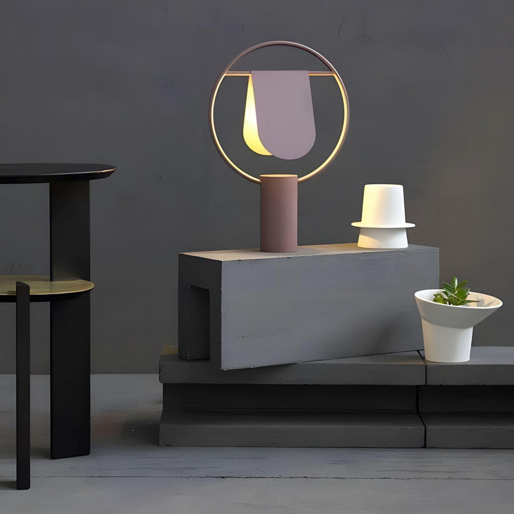 Modern table lamp design showcasing a stylish light fixture on a minimalist display with decorative planters.