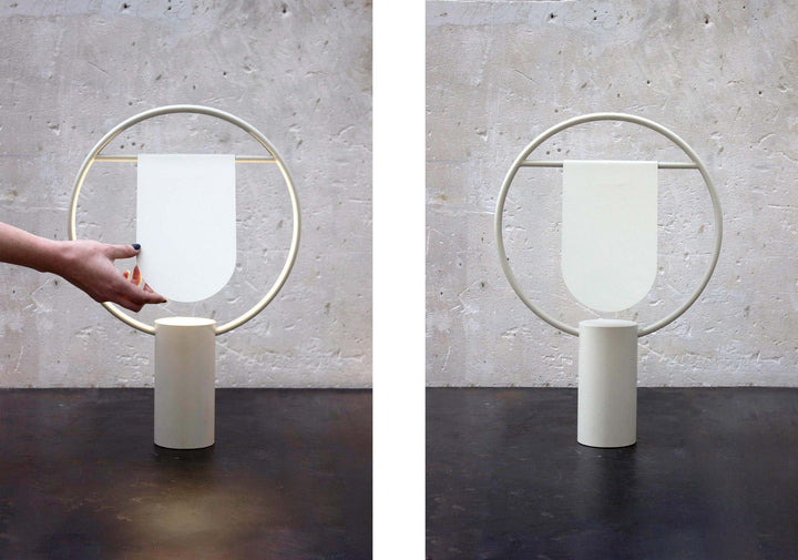 Modern table lamp with white shade and circular design, perfect for minimalist decor and stylish bedroom lighting.