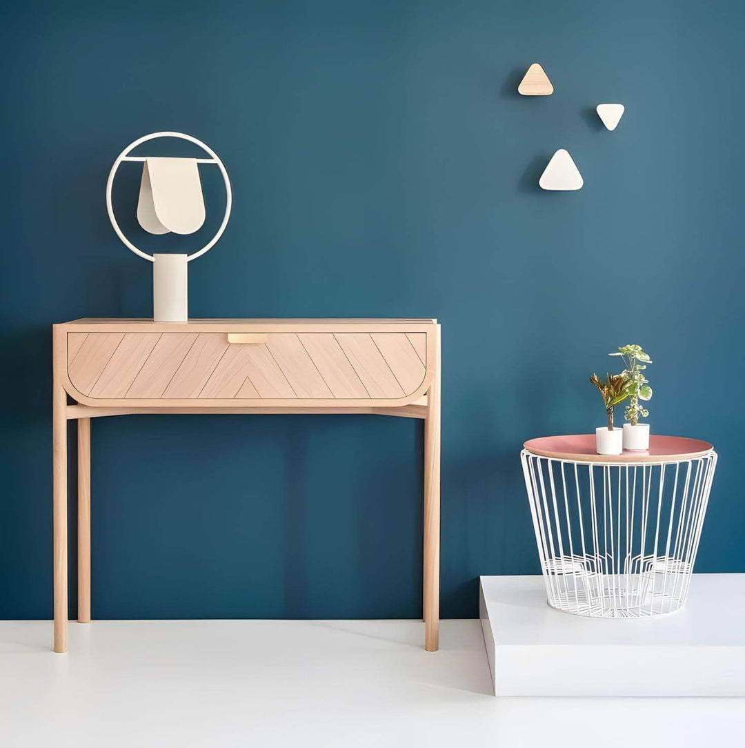 Modern minimalist interior featuring a wooden console table, geometric decor, and a stylish table lamp.