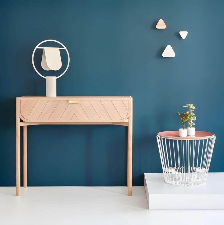 Modern minimalist interior featuring a wooden console table, geometric decor, and a stylish table lamp.