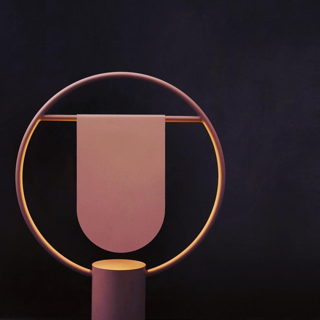 Modern table lamp with a circular design, art deco style, perfect for bedside decor in black bedroom settings.