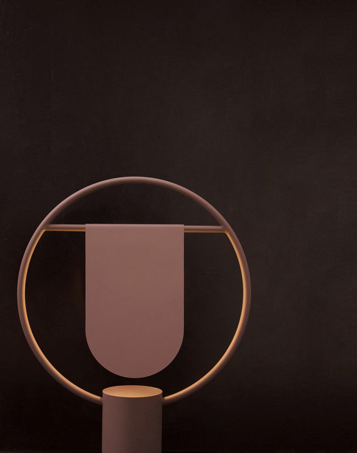 Anae Table Lamp in modern art deco style, featuring circular shape and a sleek design, perfect for bedside use.