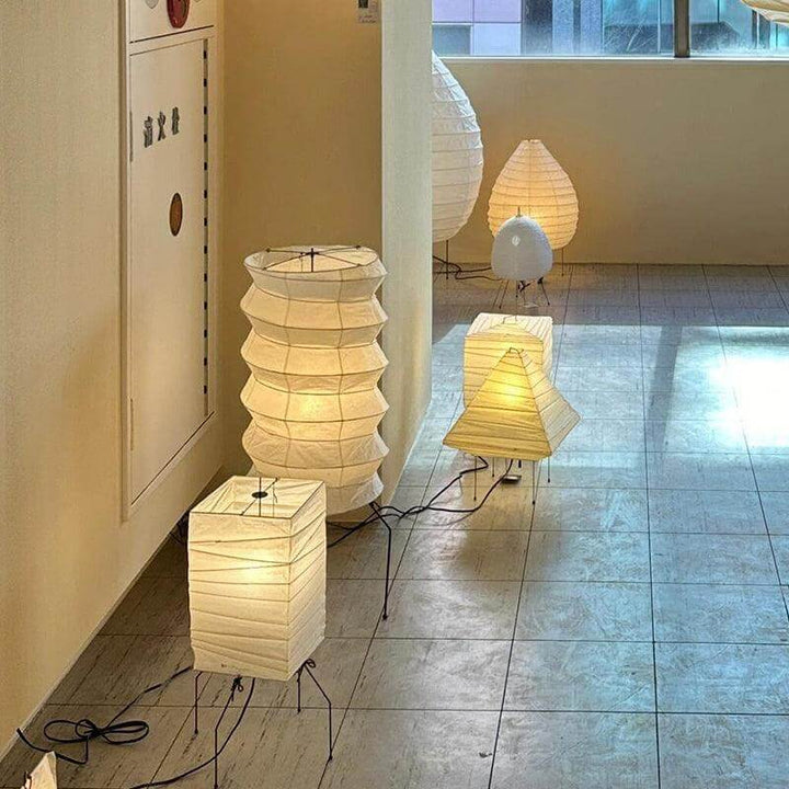 Stylish Japandi table lamps in a modern living room setting, featuring unique tripod designs and warm lighting.