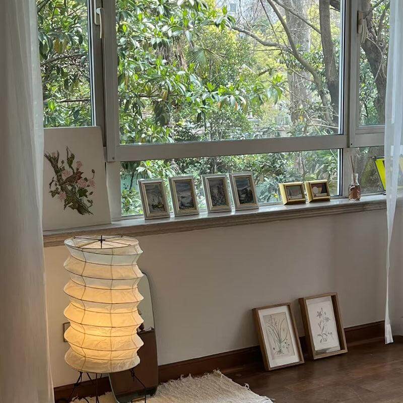 Washi Paper UF2-31N tripod table lamp in a modern living room, enhancing the Japandi aesthetic with soft lighting.