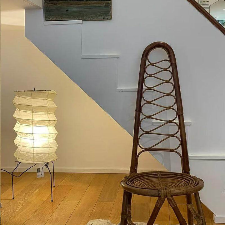 Washi Paper UF2-31N tripod table lamp beside a wicker chair, enhancing a modern Japandi living room aesthetic.