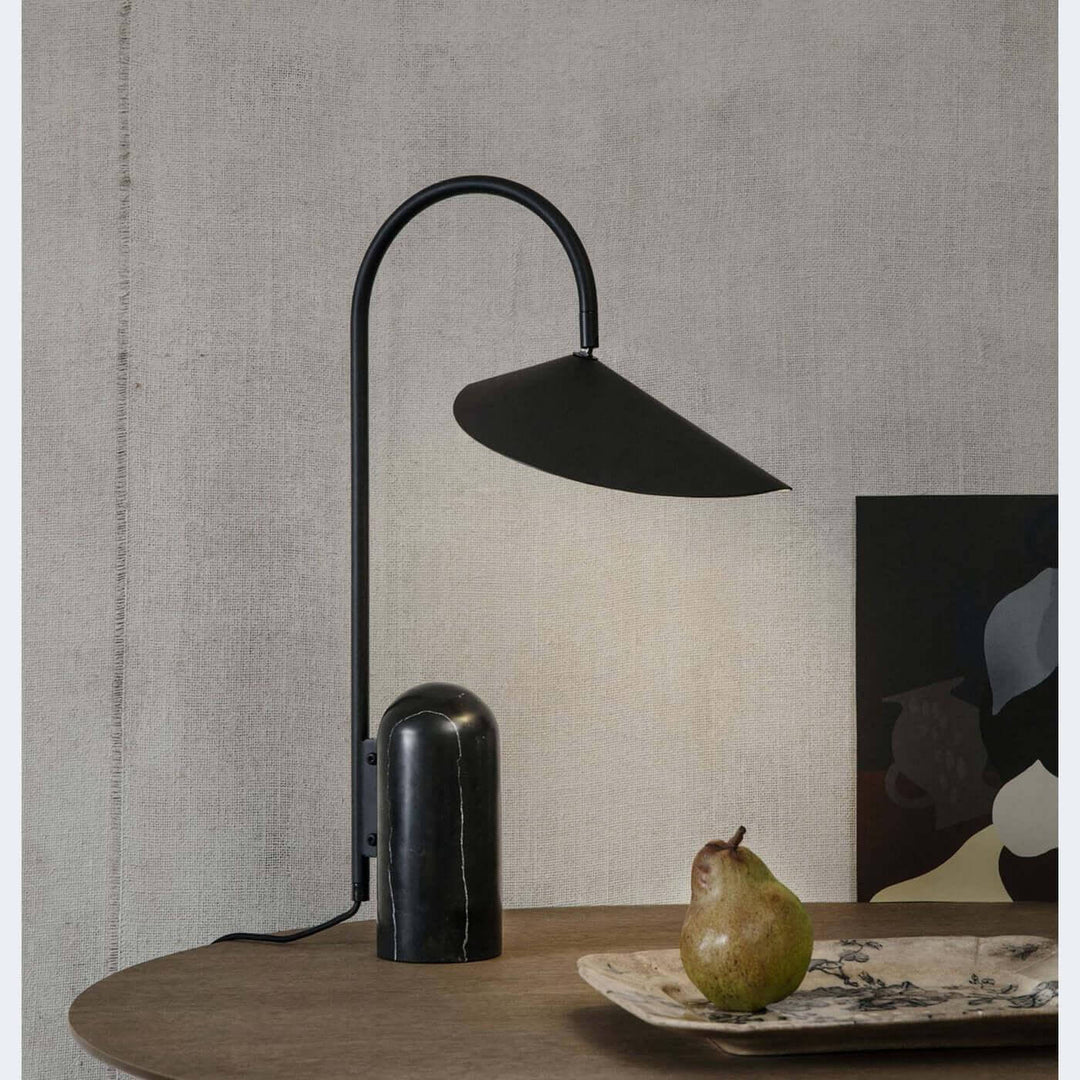 Arum table lamp, a modern black marble lamp ideal for office or living room decor on a wooden table.