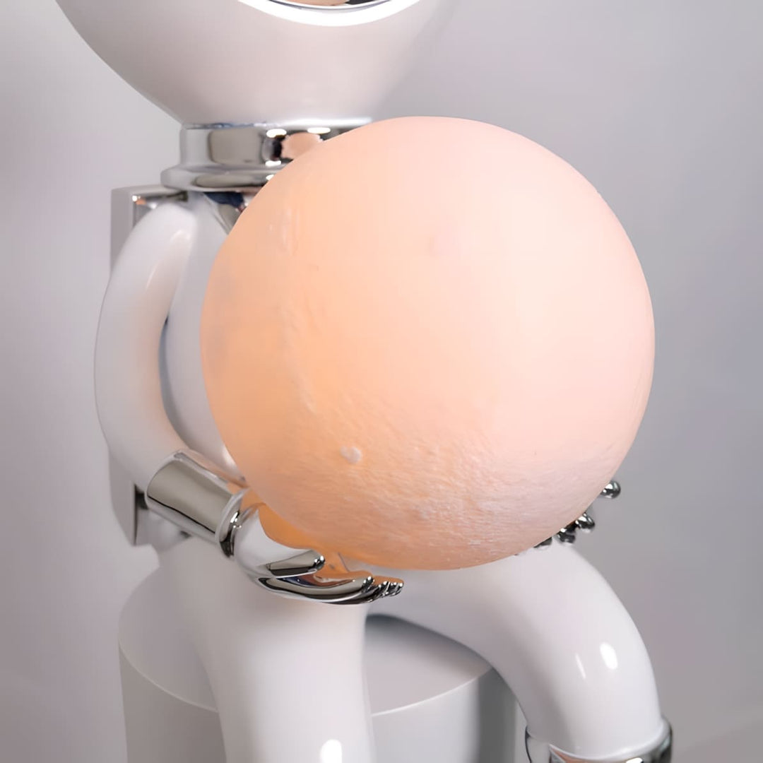 Sculptural lamp with a character holding a moon-shaped light, perfect for modern decor.
