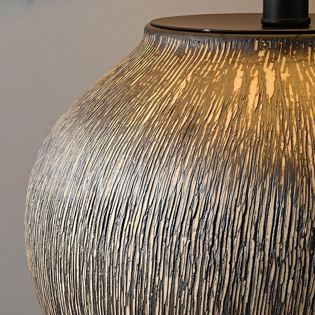 Close-up of Bayi ceramic table lamp showcasing its textured finish and warm glow, ideal for vintage and sofa table settings.