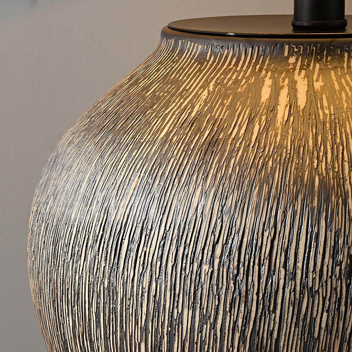 Close-up of Bayi ceramic table lamp showcasing its textured finish and warm glow, ideal for vintage and sofa table settings.