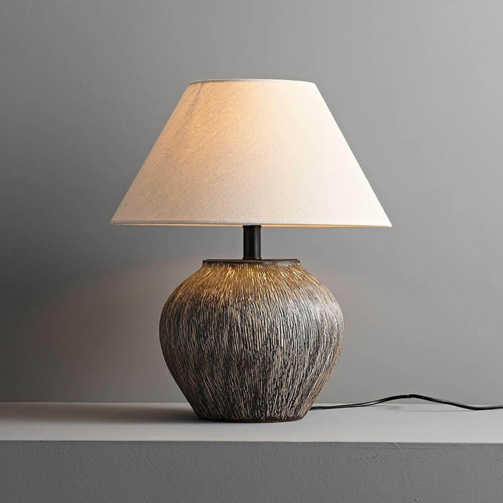 Bayi ceramic table lamp with a textured base and a fabric shade, perfect for vintage decor and sofa tables.