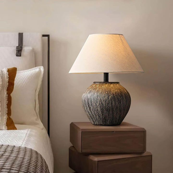 Bayi ceramic table lamp on a bedside table, adding vintage charm and warm light to a cozy bedroom.