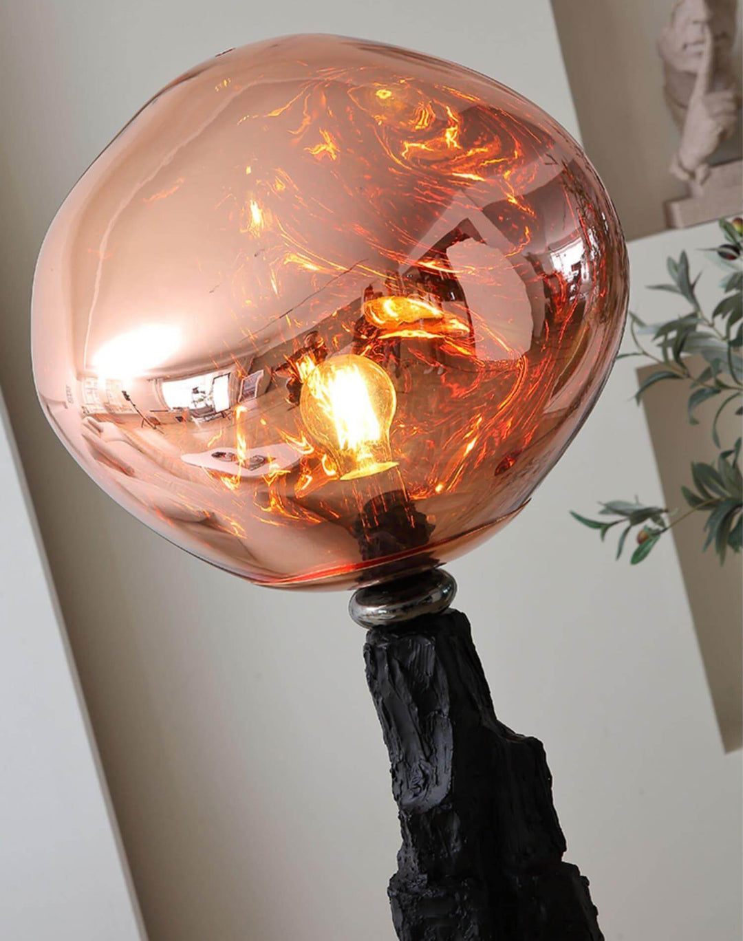 Unique charcoal lava floor lamp featuring an art deco design with an eye-catching copper globe shade.