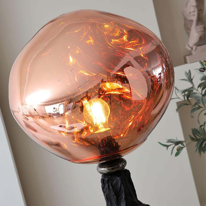 Charcoal Lava Floor Lamp with unique art deco design, showcasing an unusual glass shade illuminating a warm light.