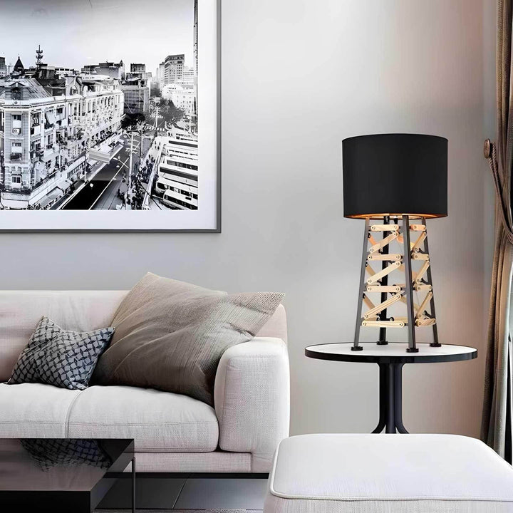 Modern Eiffel table lamp with black shade on a stylish side table in a contemporary living room setting.