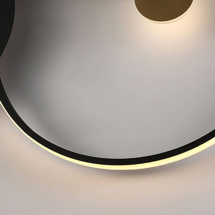 Close-up of a black wall sconce, featuring a modern double round design with soft lighting. Ideal for bedroom lamps on wall.