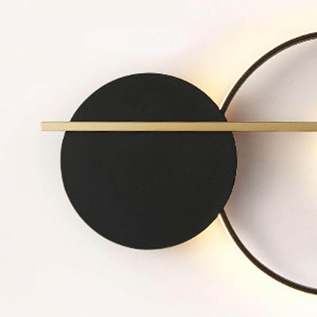 Black round wall sconce with gold accent, perfect for modern bedroom lamps on wall and stylish lighting decor.