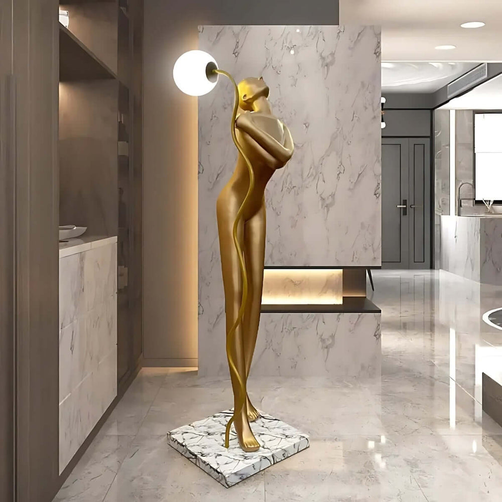 Sculptural art deco floor lamp with golden figure design, perfect for stylish living room lighting.