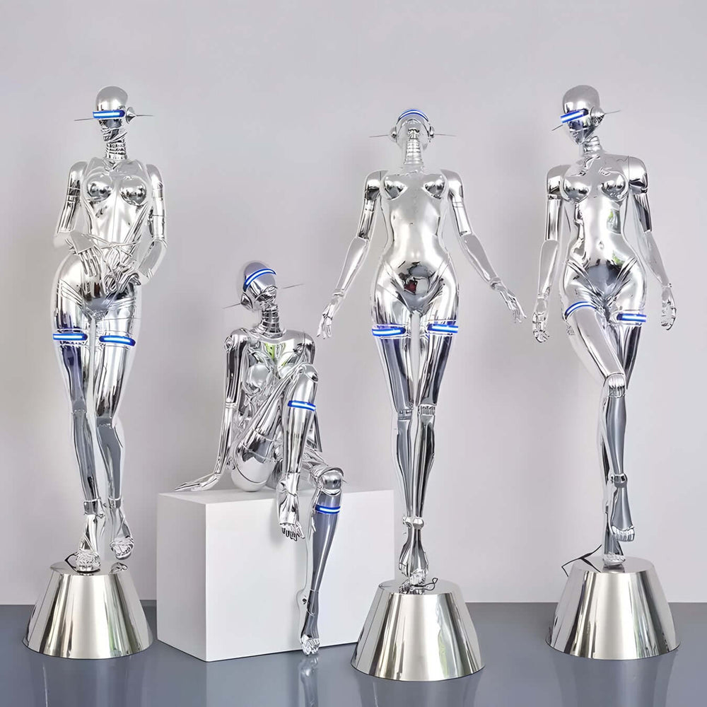 A group of stylish silver mannequins with futuristic designs, showcasing trendy aesthetics and art deco influences.