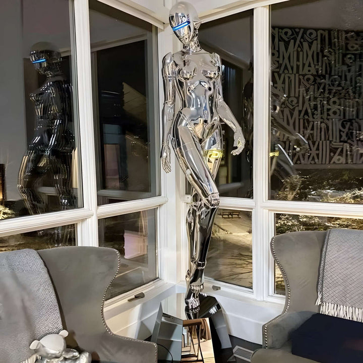 Sculptural chrome floor lamp resembling a female figure, adding a trendy Art Deco touch to modern living room decor.
