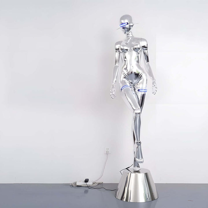 Sculptural floor lamp in a sleek silver finish, ideal for modern and art deco living room decor.