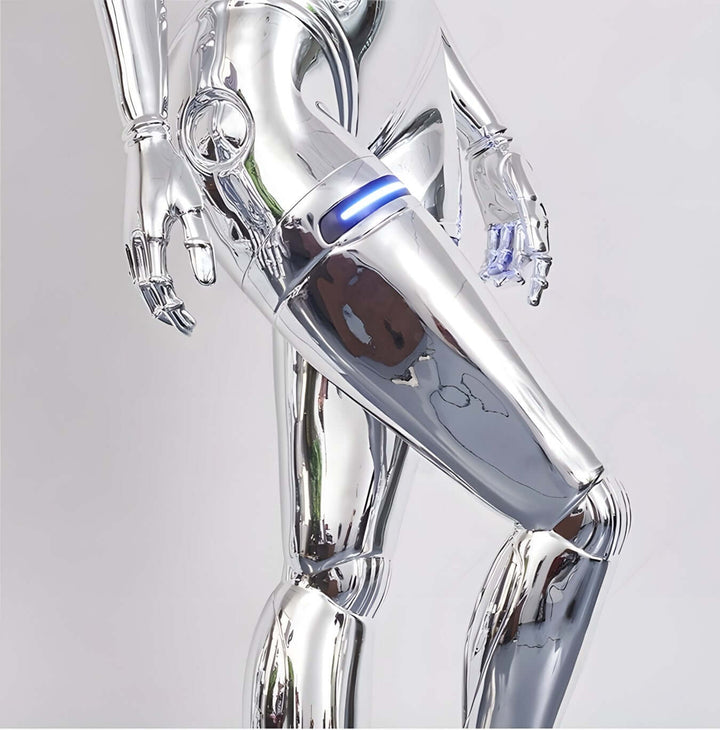Close-up of a reflective silver robot leg with blue light detail, showcasing futuristic design and sleek metallic finish.