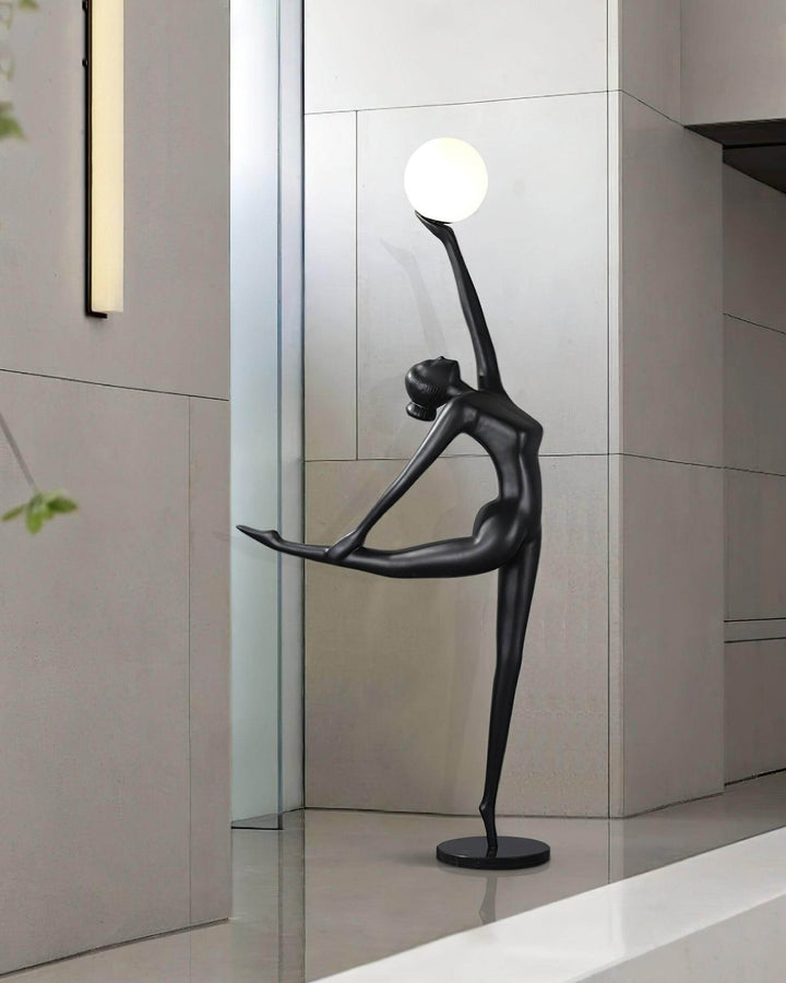 Sculptural art deco floor lamp in black, designed as a graceful figure, perfect for modern living room decor.