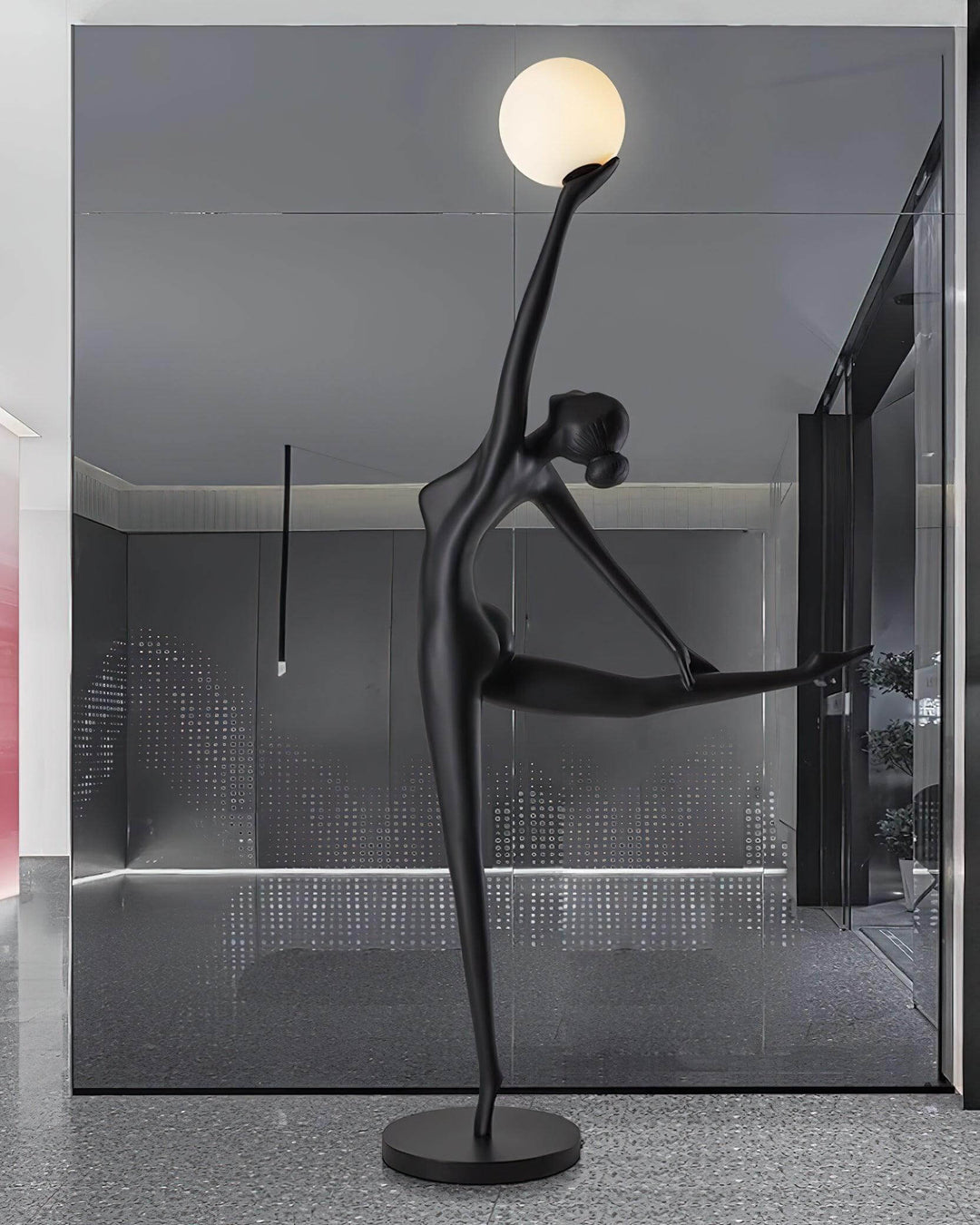 Sculptural art deco floor lamp in black, featuring a dancer pose with a round light, perfect for living room decor.