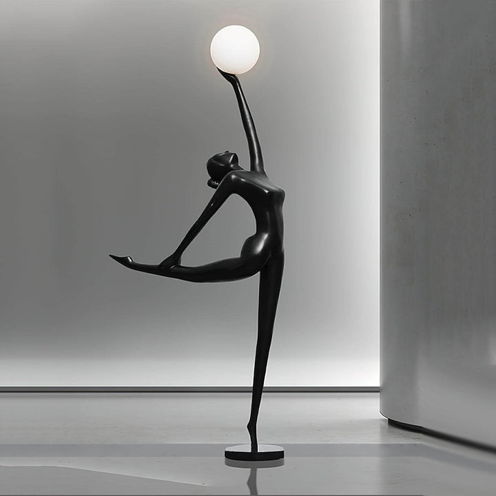 Sculptural art deco floor lamp featuring a dancer holding a glowing orb, perfect for modern living room decor.