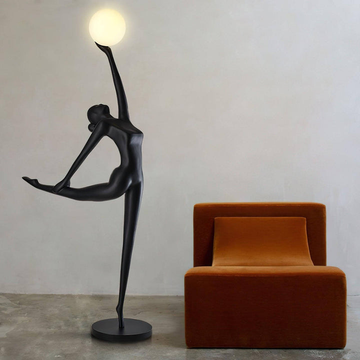 Sculptural art deco floor lamp beside a modern orange chair, adding elegance to the living room ambiance.