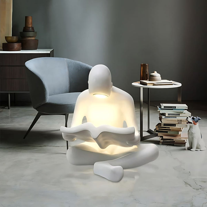 Elyvia sculptural floor lamp in a modern living room, featuring a seated figure reading, perfect art deco floor light.