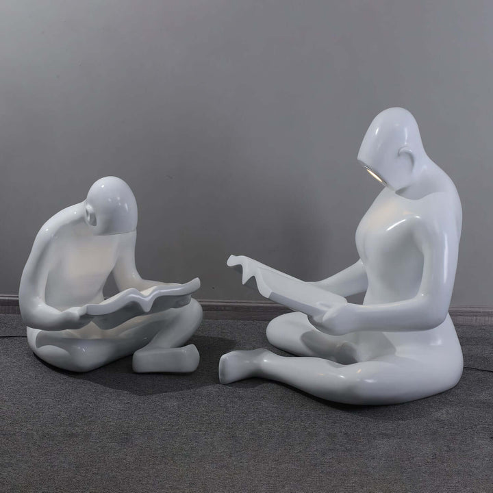 Elyvia sculptural floor lamp featuring art deco design with figures reading, ideal floor lights for living room decor.