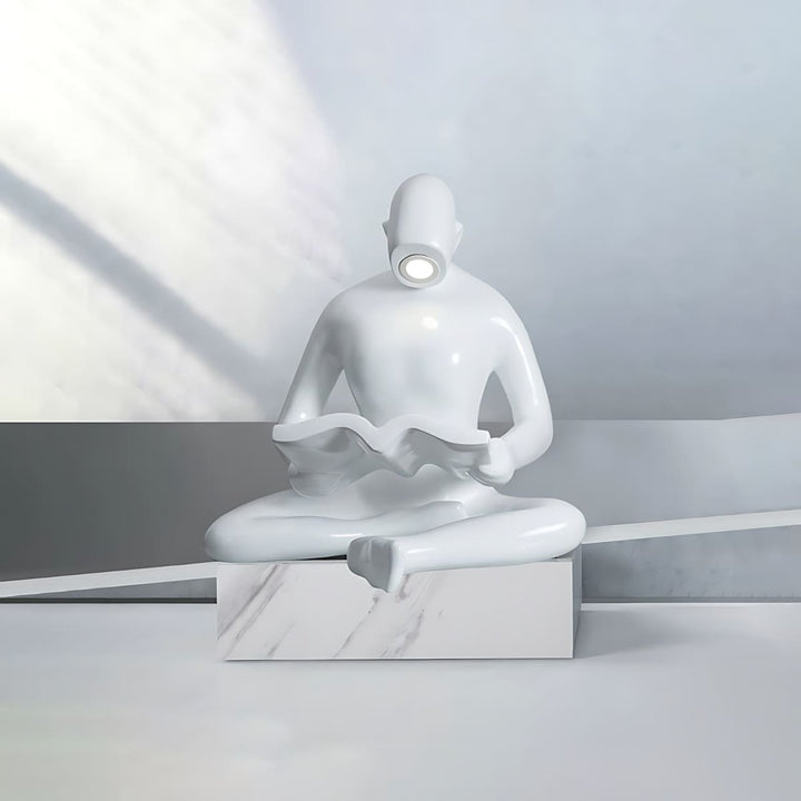 Elyvia sculptural floor lamp featuring a minimalist seated figure reading, ideal for living room decor in art deco style.