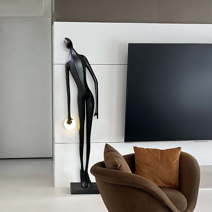 Stylish sculptural floor lamp in a modern living room, enhancing decor with art deco elegance and black tones.