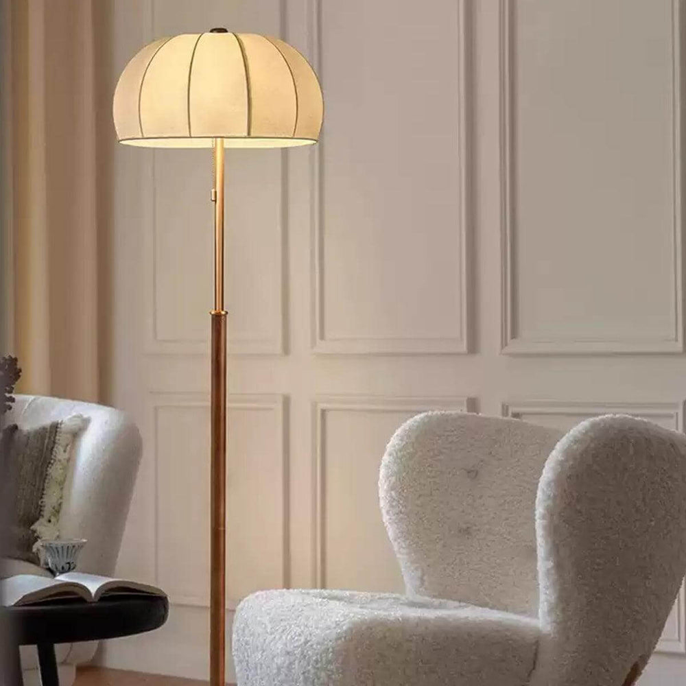Gorra floor lamp in mid-century style, wood floor light with a cozy design beside a plush chair, perfect for farmhouse decor.
