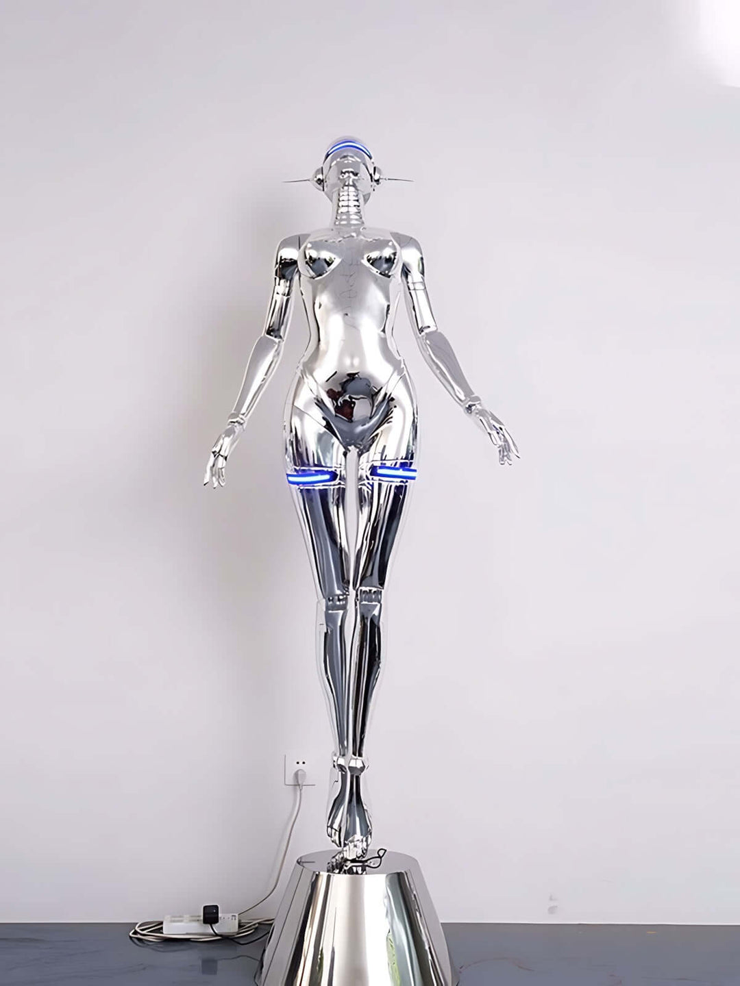 Sculptural silver floor lamp with a modern, art deco design, perfect for contemporary living room lighting.