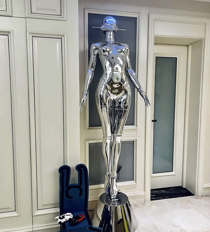 Sleek silver sculptural floor lamp in a modern living room, perfect for art deco decor and trendy lighting.