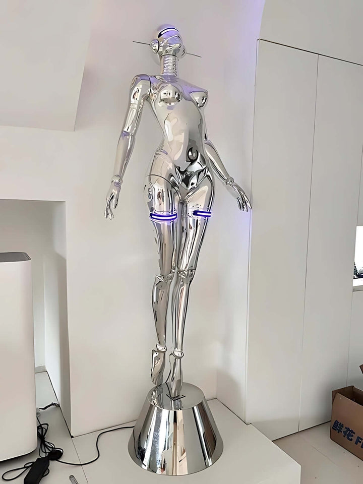 Sculptural silver floor lamp with an art deco design, featuring a human-like figure and trendy LED accents.