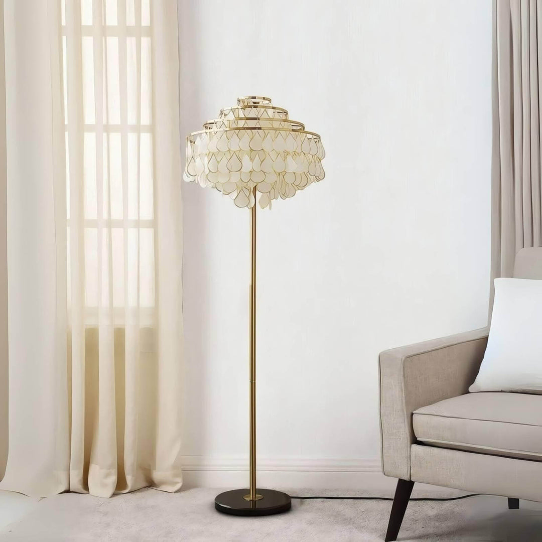 Coastal floor lamp with a decorative teardrop shell design, perfect for bedroom lighting in stylish home decor.