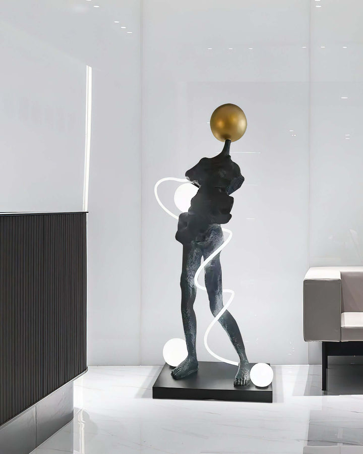 Sculptural floor lamp in modern setting, featuring a unique art deco design with gold accents and elegant curves.